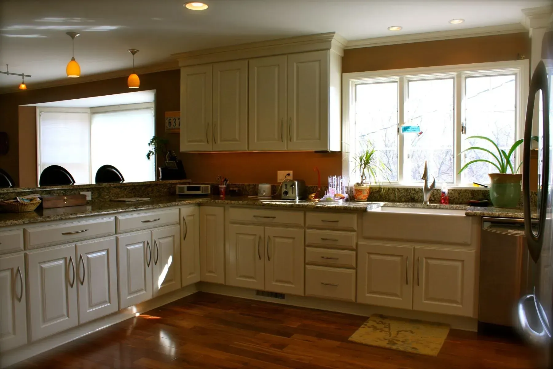 A kitchen with white cabinets and stainless steel appliances