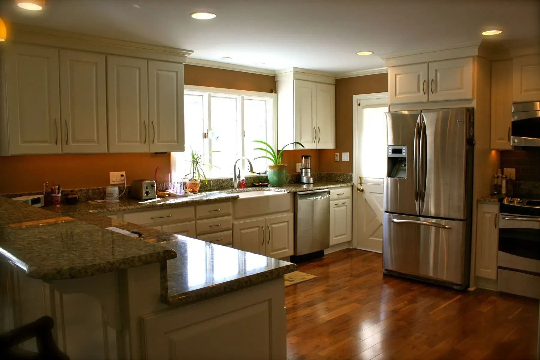 A kitchen with stainless steel appliances and white cabinets