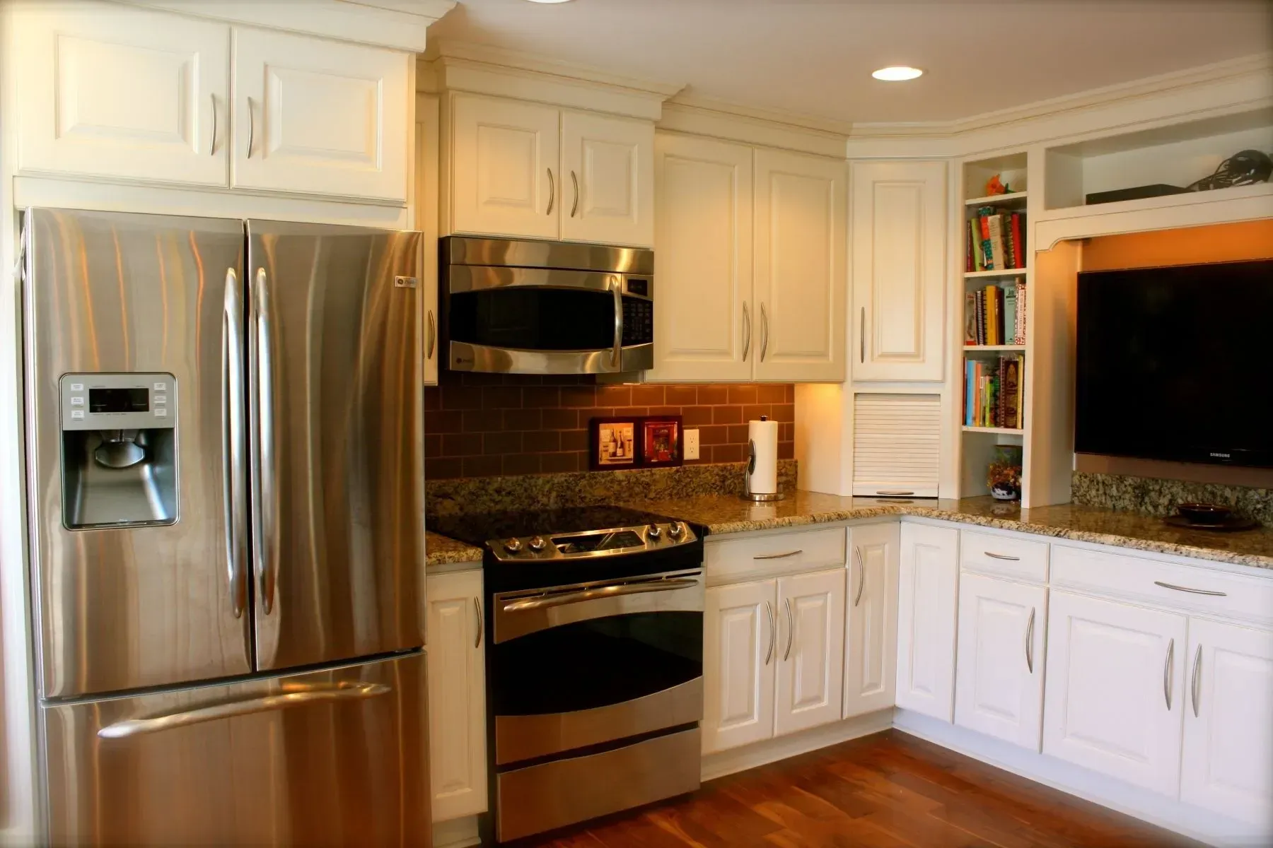 A kitchen with stainless steel appliances and white cabinets