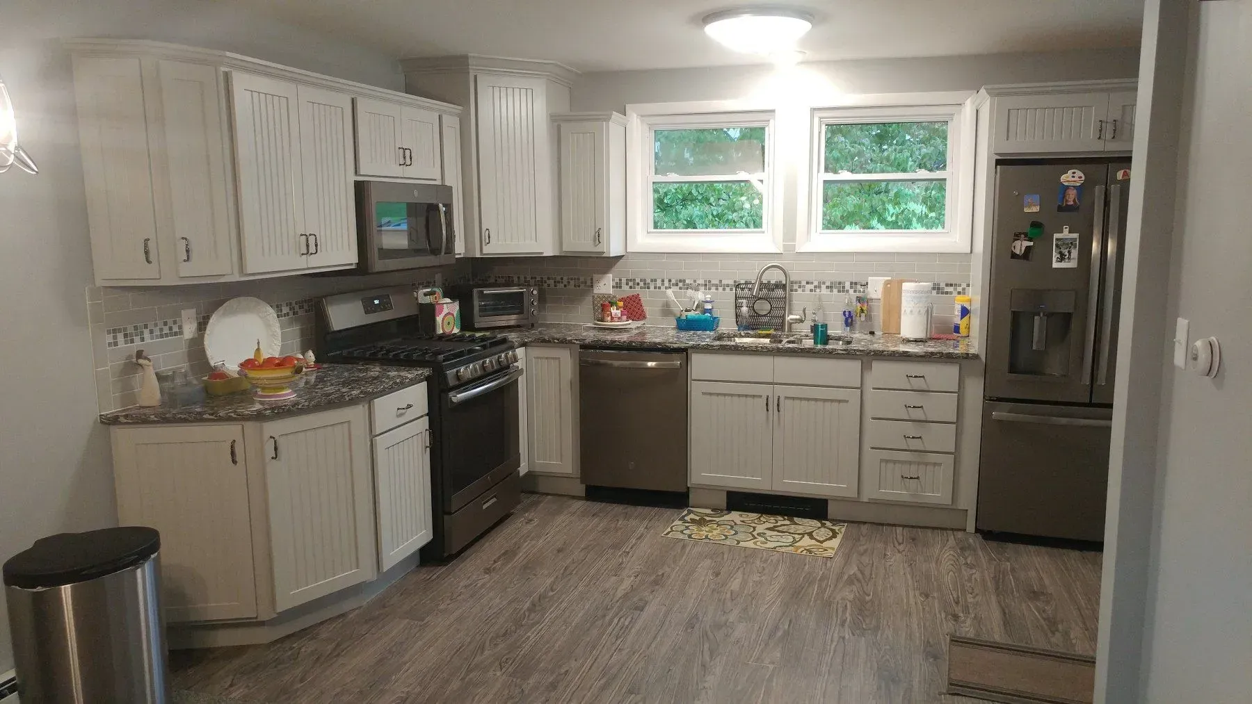 A kitchen with white cabinets and stainless steel appliances.