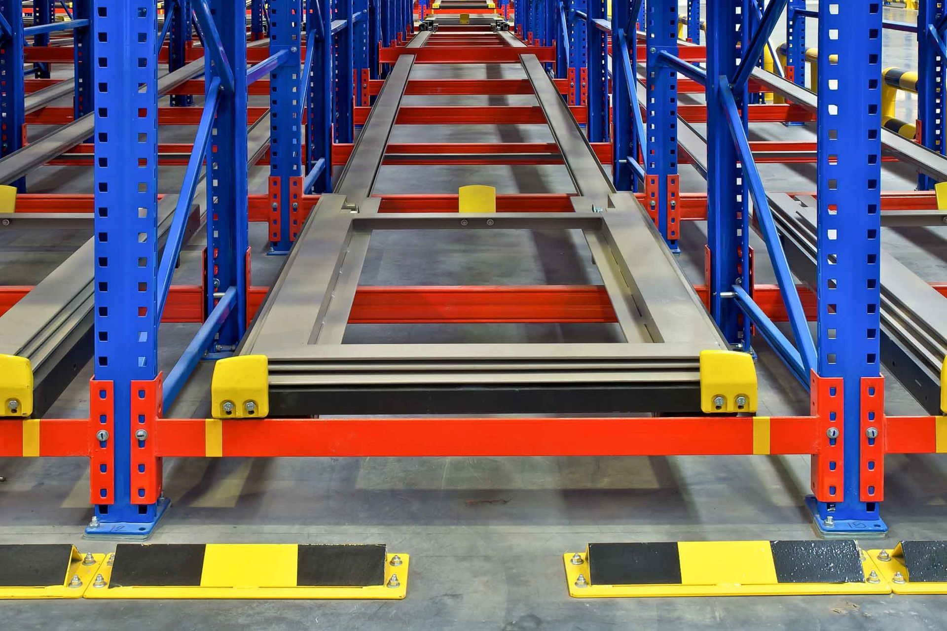 A warehouse with a lot of shelves and a conveyor belt.