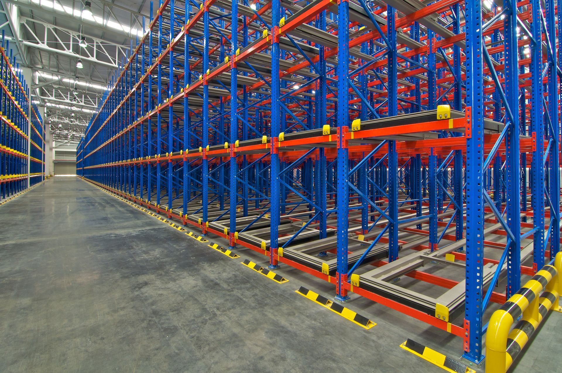 A warehouse filled with lots of shelves and conveyor belts.