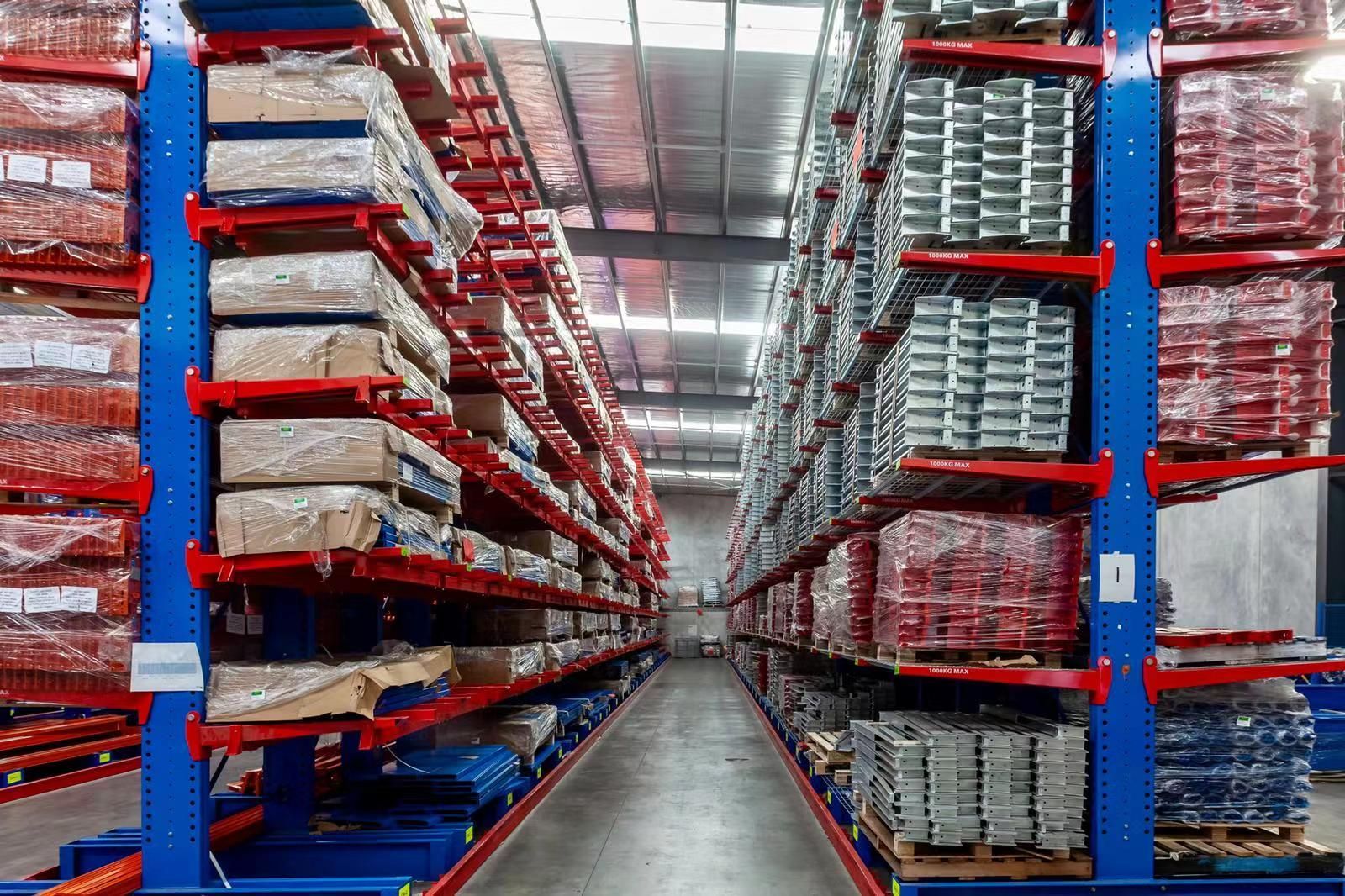 A bunch of metal tubes are stacked on top of each other in a warehouse.