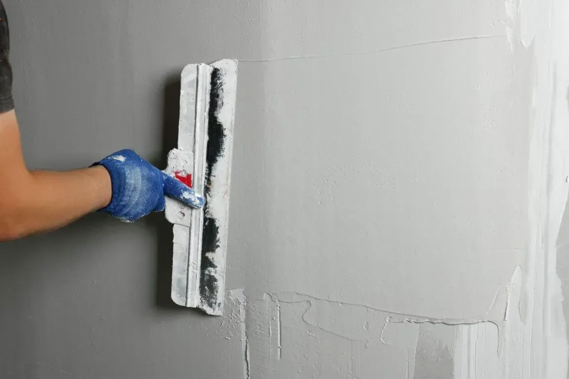 Skimming plaster on a drywall wall.