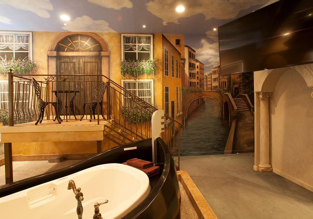 A bathroom with a bathtub and a painting on the wall