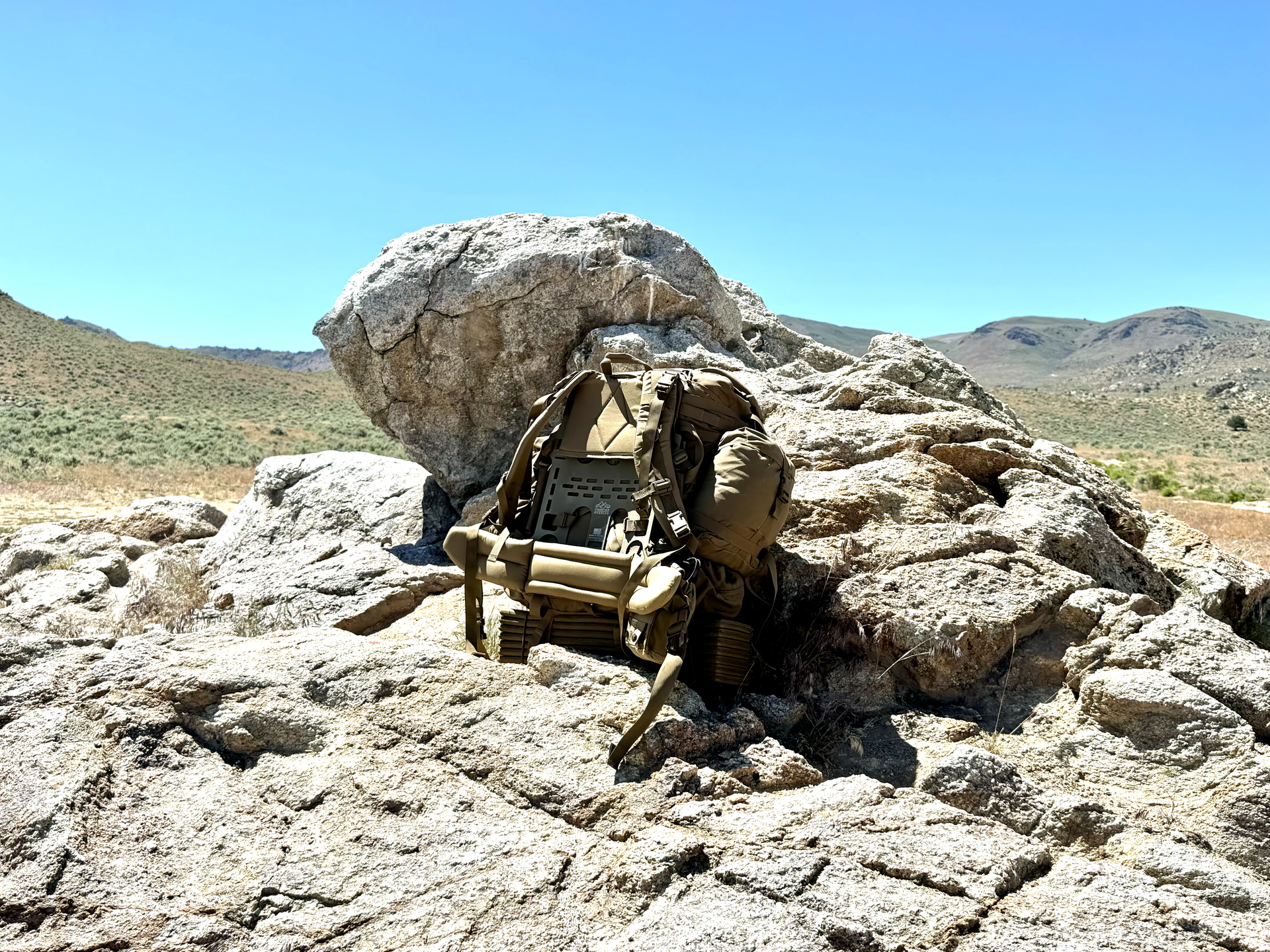 A treasure chest is sitting on top of a large rock in the desert.
