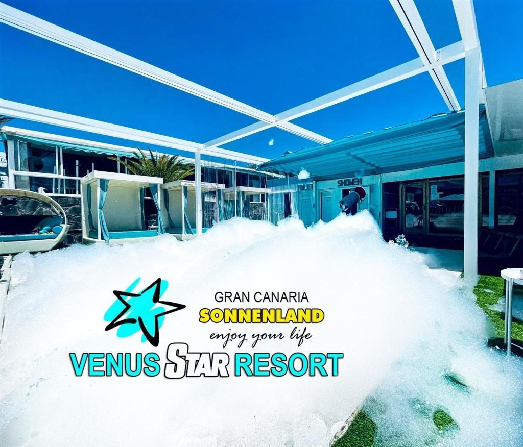 Venue sign at Venus Star Resort in Gran Canaria under a blue canopy with white foam on the ground