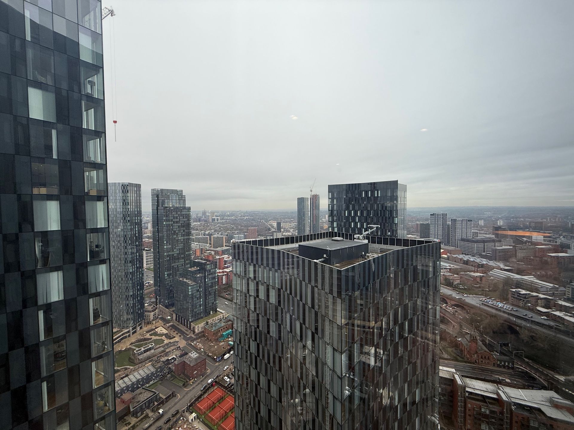 High-angle view of a city skyline with modern skyscrapers on a cloudy day.