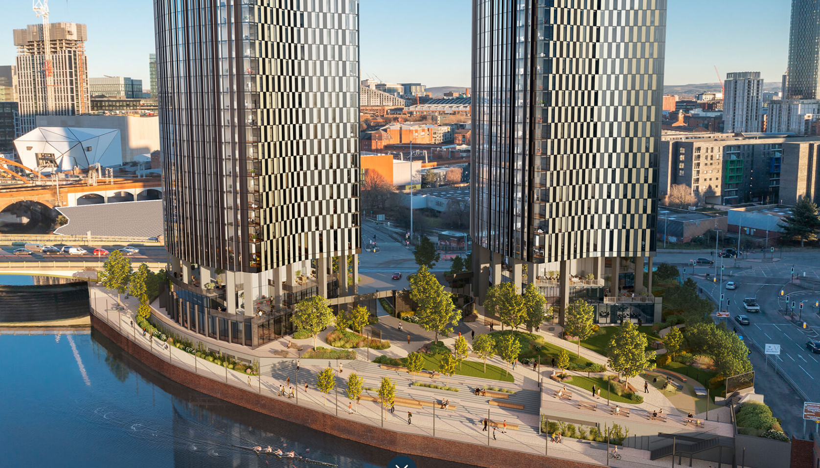 Two modern skyscrapers with patterned facades, set by a river with a public garden below.