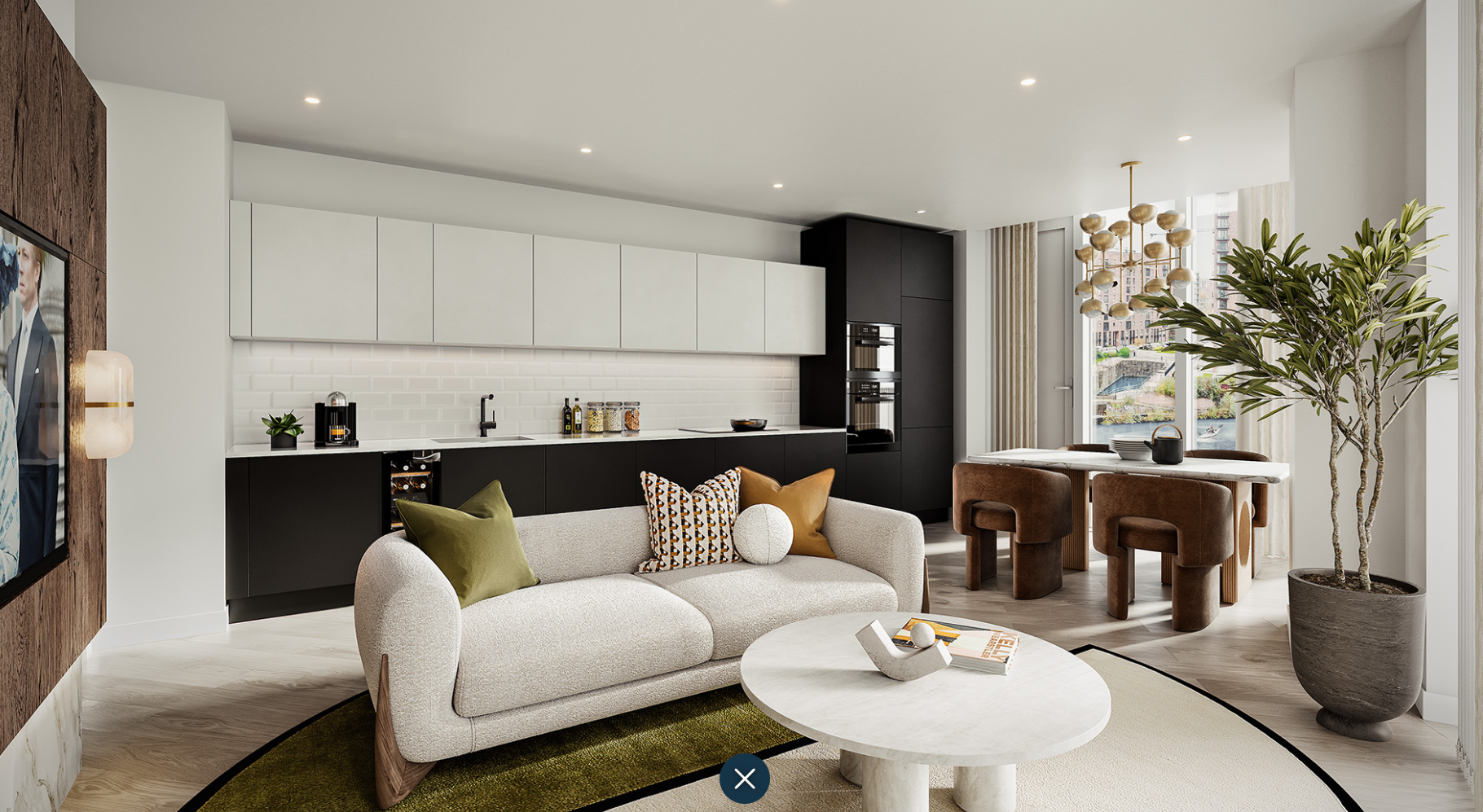 Modern living room with white and black cabinets, a sofa, and a dining area.