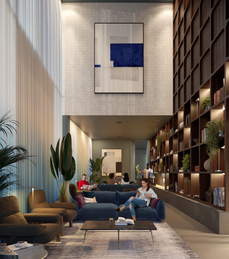 Modern lounge area with people relaxing. Features a large bookshelf, blue couch, and abstract art.