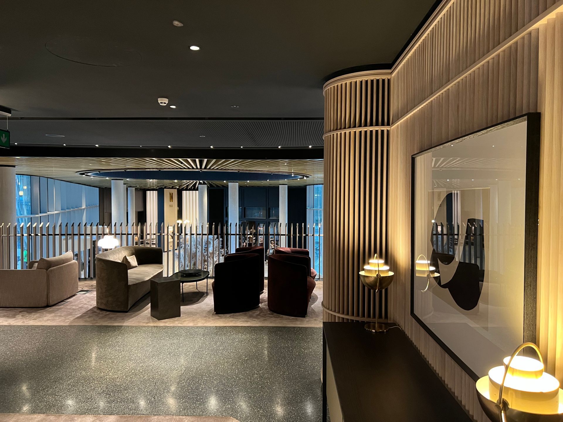 Lounge area in modern style with seating, artwork, and accent lighting.