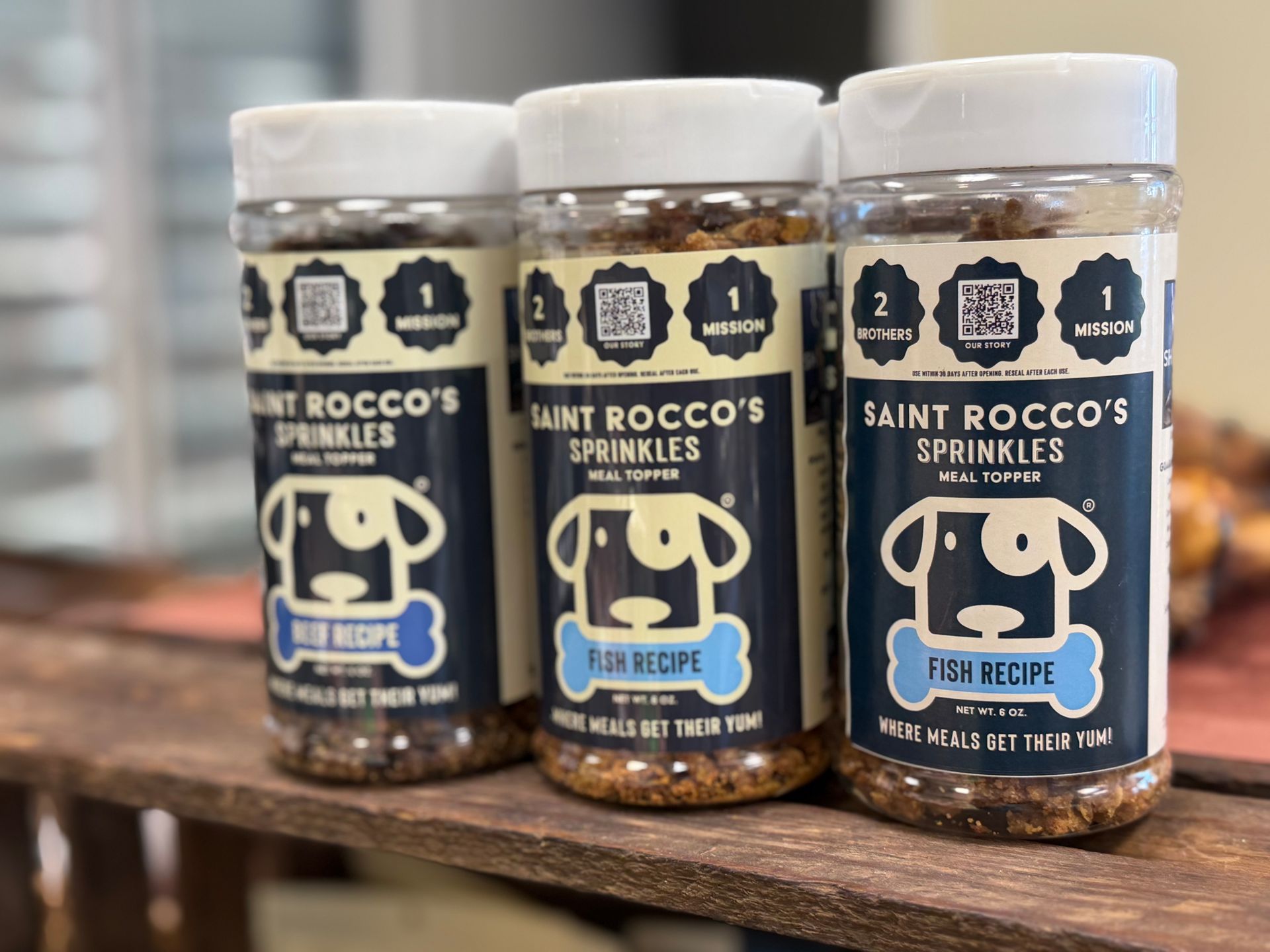 Three Saint Rocco’s Sprinkle jars on a counter, labeled “Fruity Pebbles” and “Frosty Flakes” alternatives