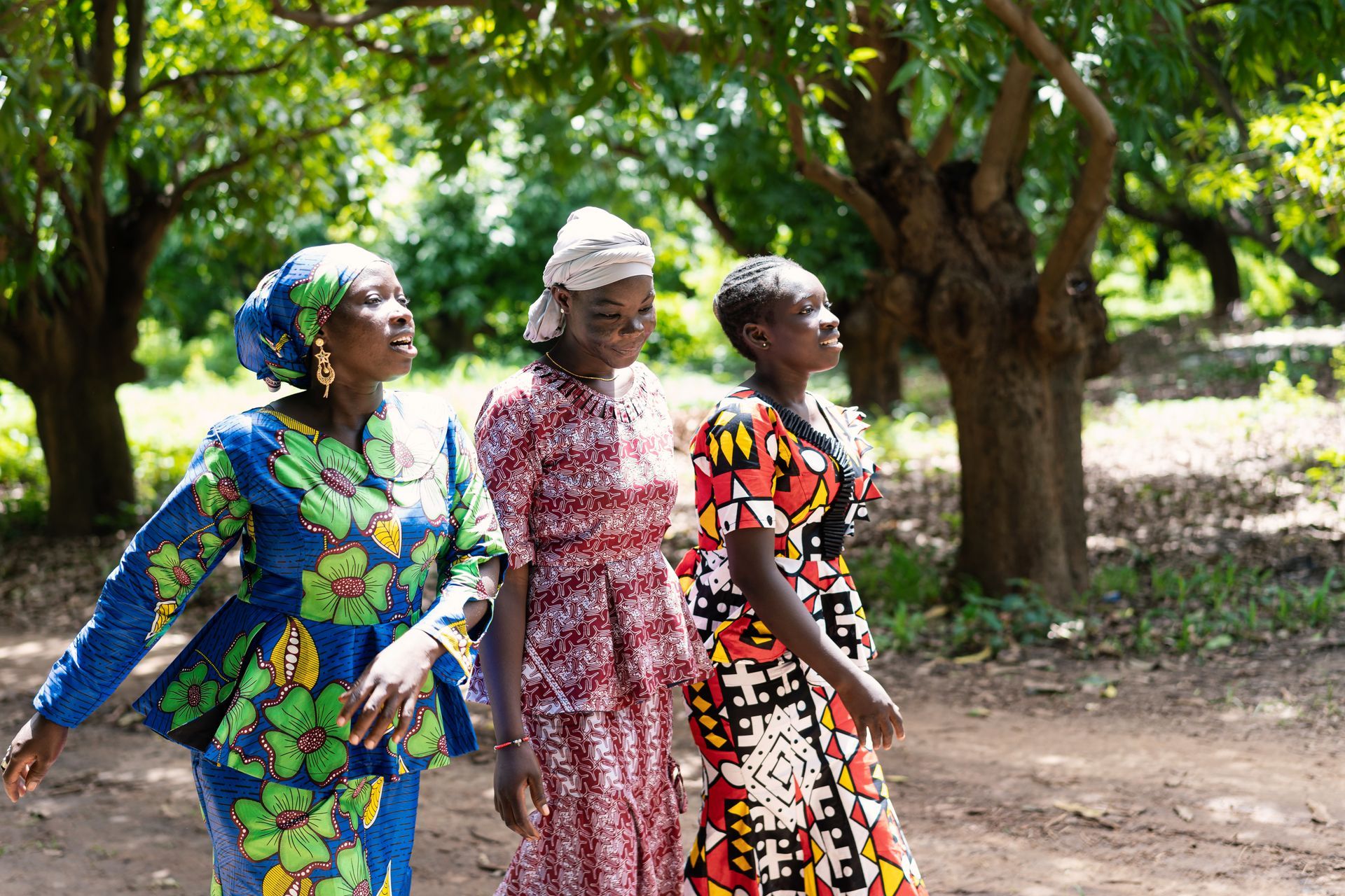 Women walking together along a dirt road in Nigeria