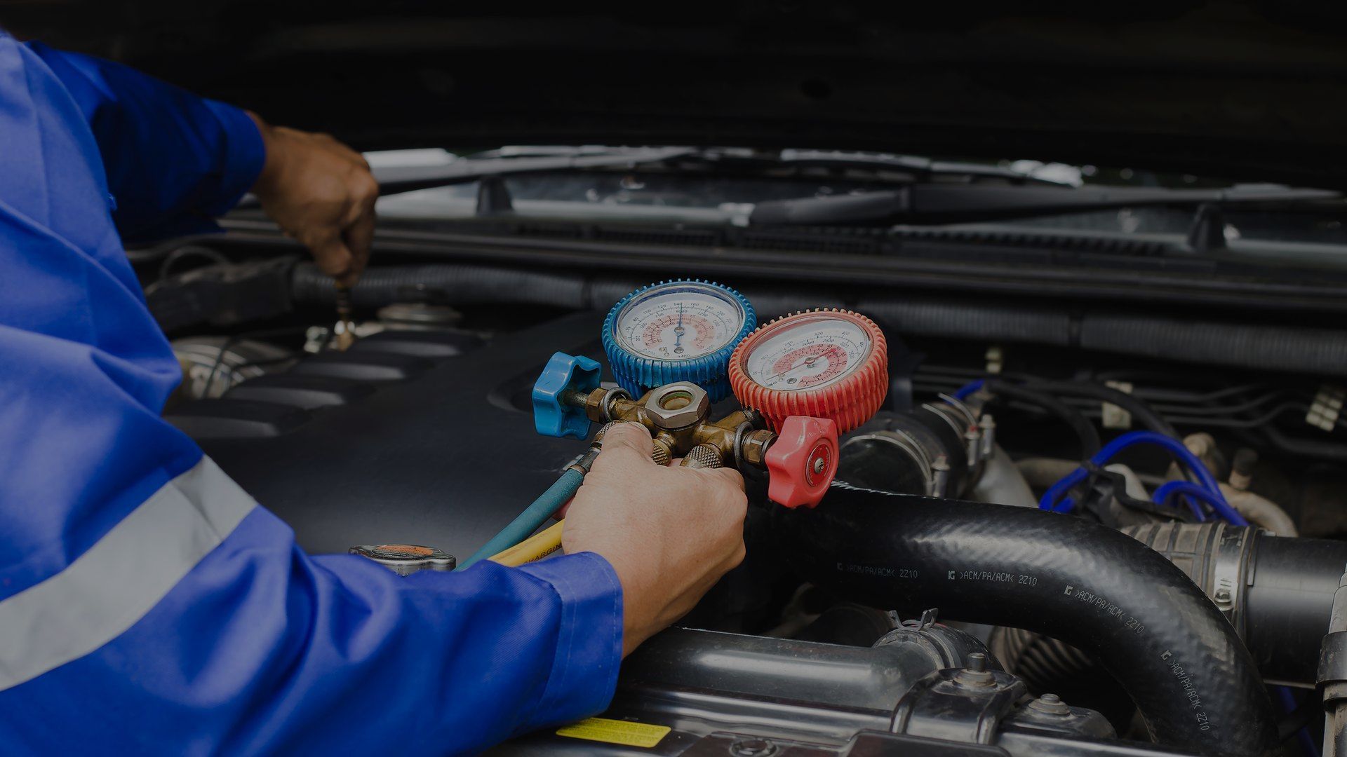 A person is pouring oil into a car engine.