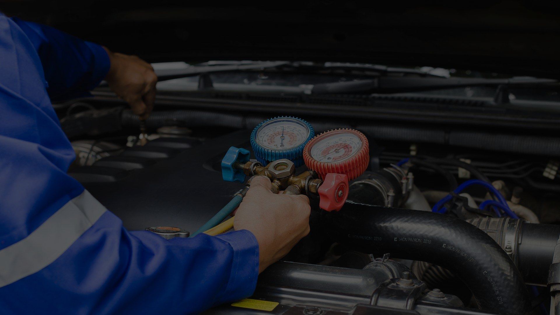 A person is pouring oil into a car engine.