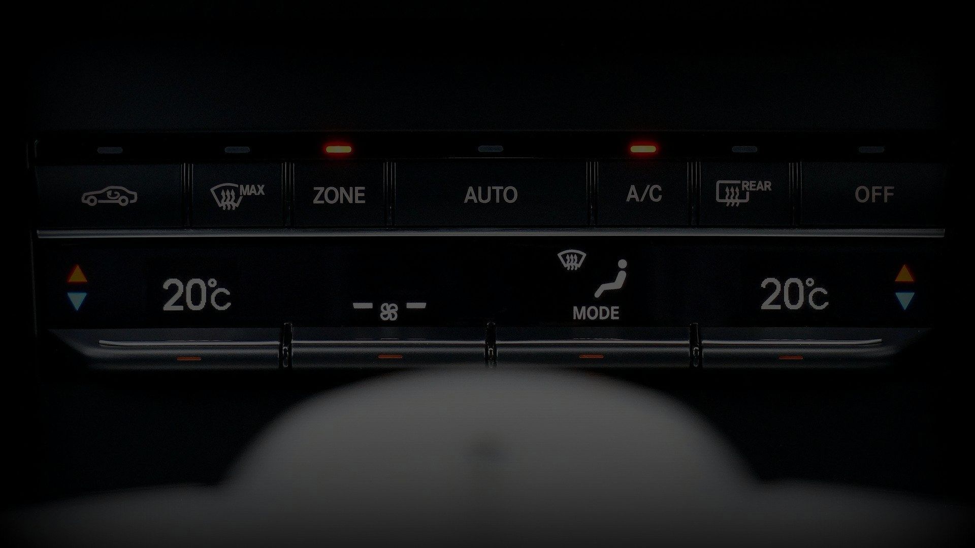 A close up of a car 's climate control with the temperature set at 20 degrees celsius