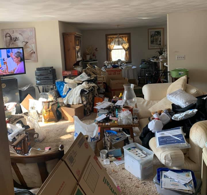 A living room with a lot of boxes on the floor