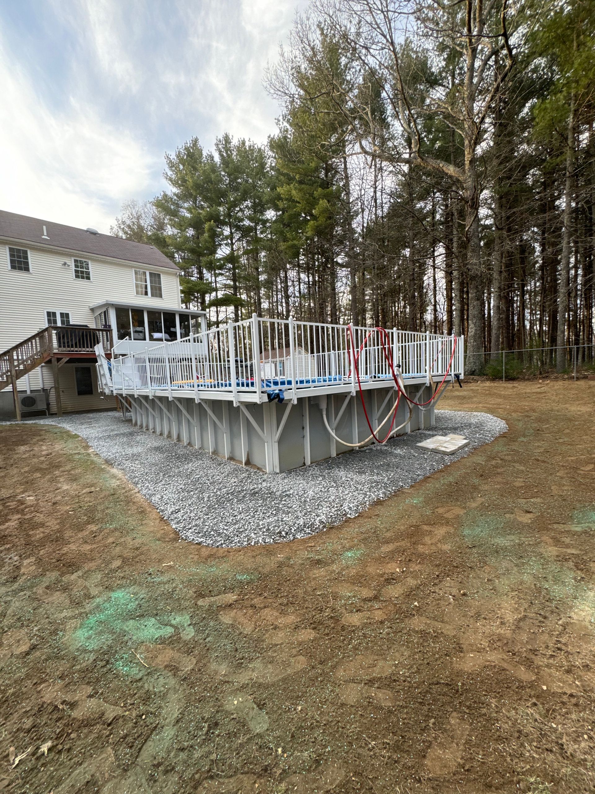 A swimming pool is being built in the backyard of a house.