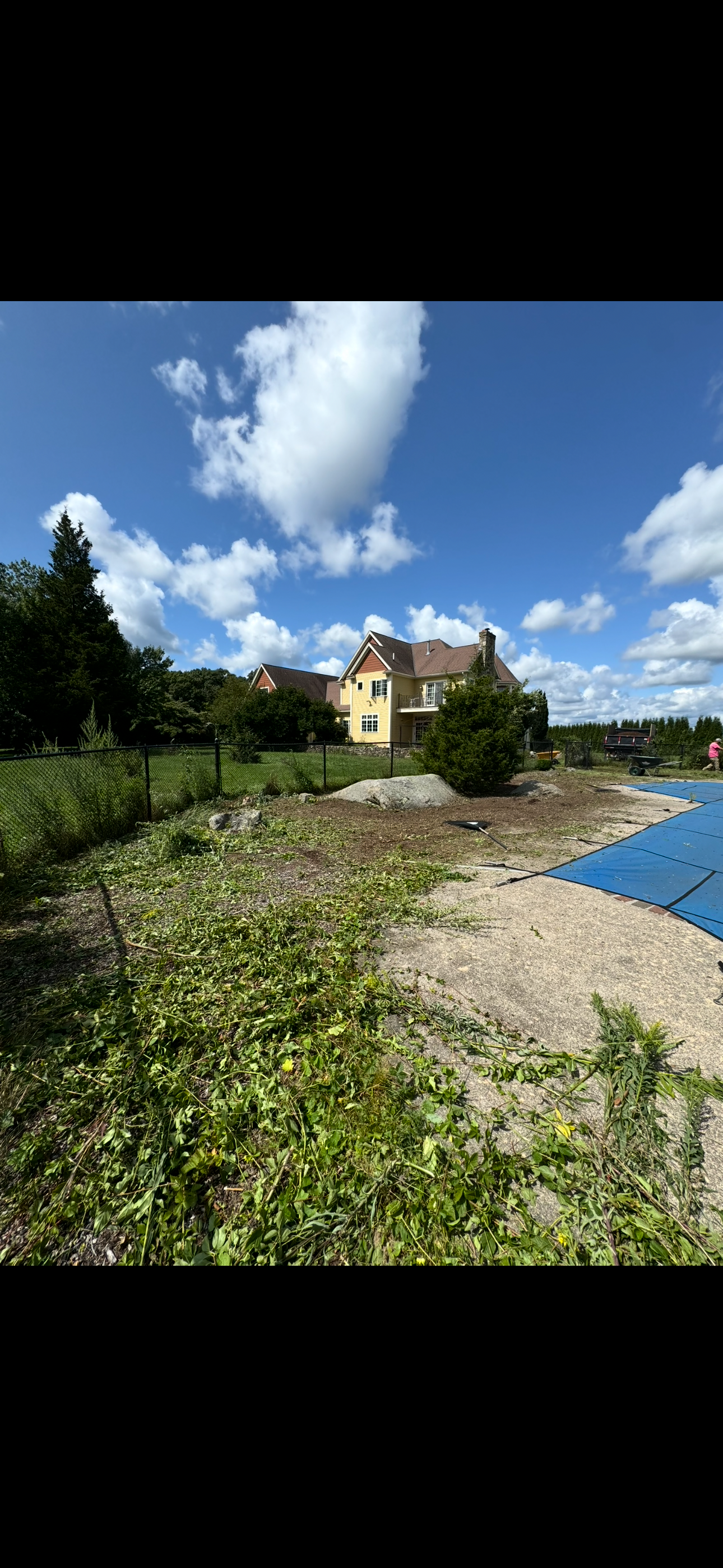 A large house is sitting on the shore of a lake.