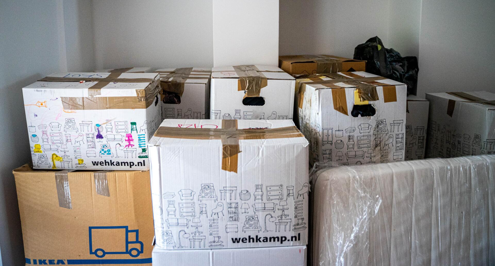 A bunch of cardboard boxes are stacked on top of each other