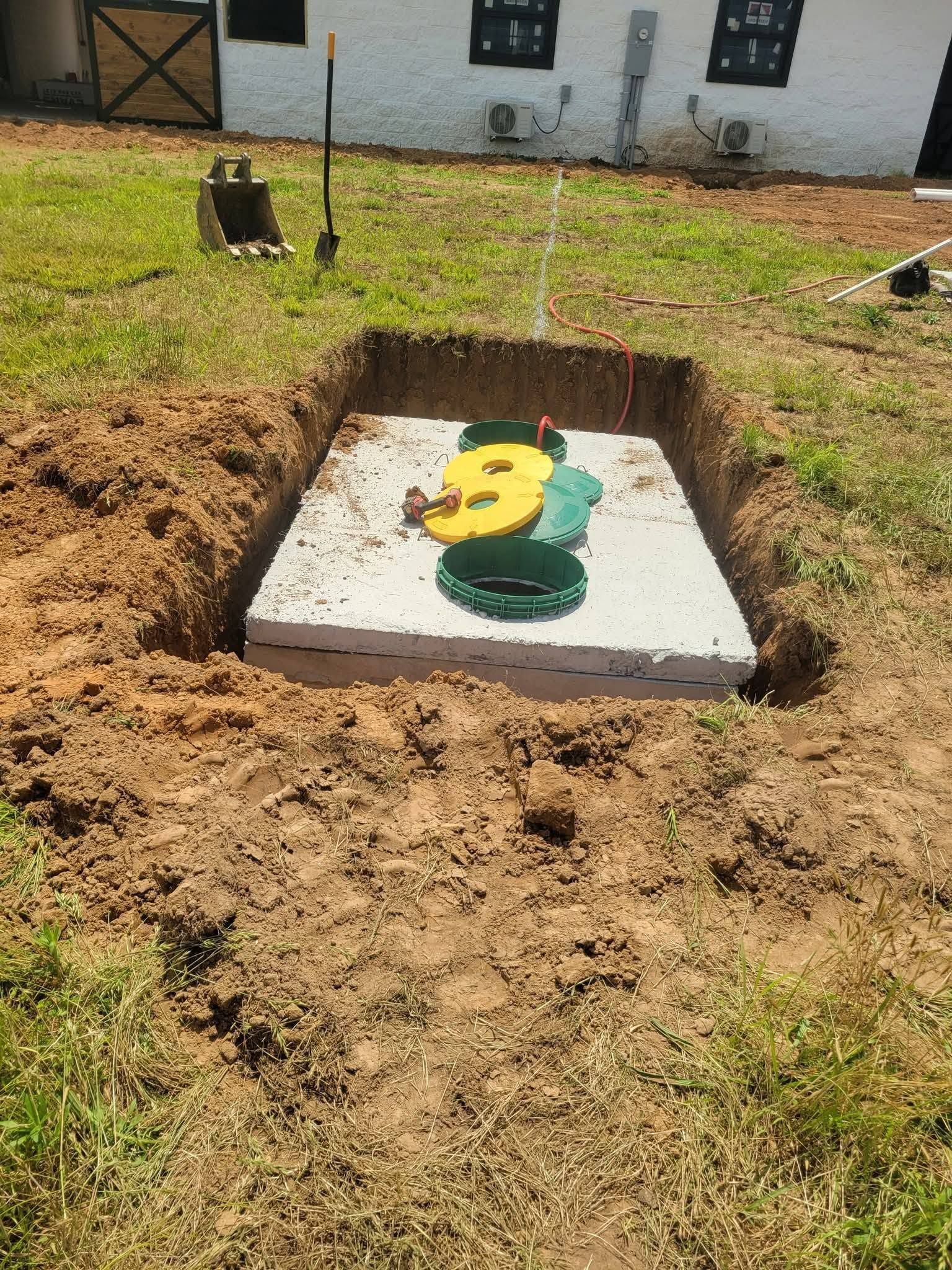Yellow and green decorative marker set in a dug-out square patch of soil on a lawn