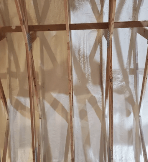 Wooden rafters and supports against a white or light-colored background.