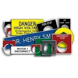 Assorted industrial safety signs and emergency stop labels in red, yellow, and green.