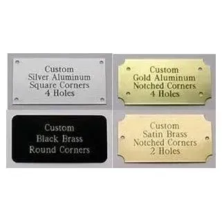 Four custom metal plaques in silver, gold, black, and satin brass with different corner styles and hole counts