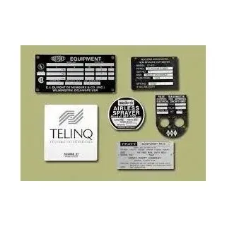 Assorted equipment labels and stickers on a light green background, including a large TELINQ card and black tags.