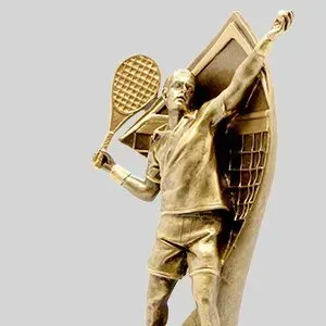 Gold tennis player trophy statue with racket raised in celebration