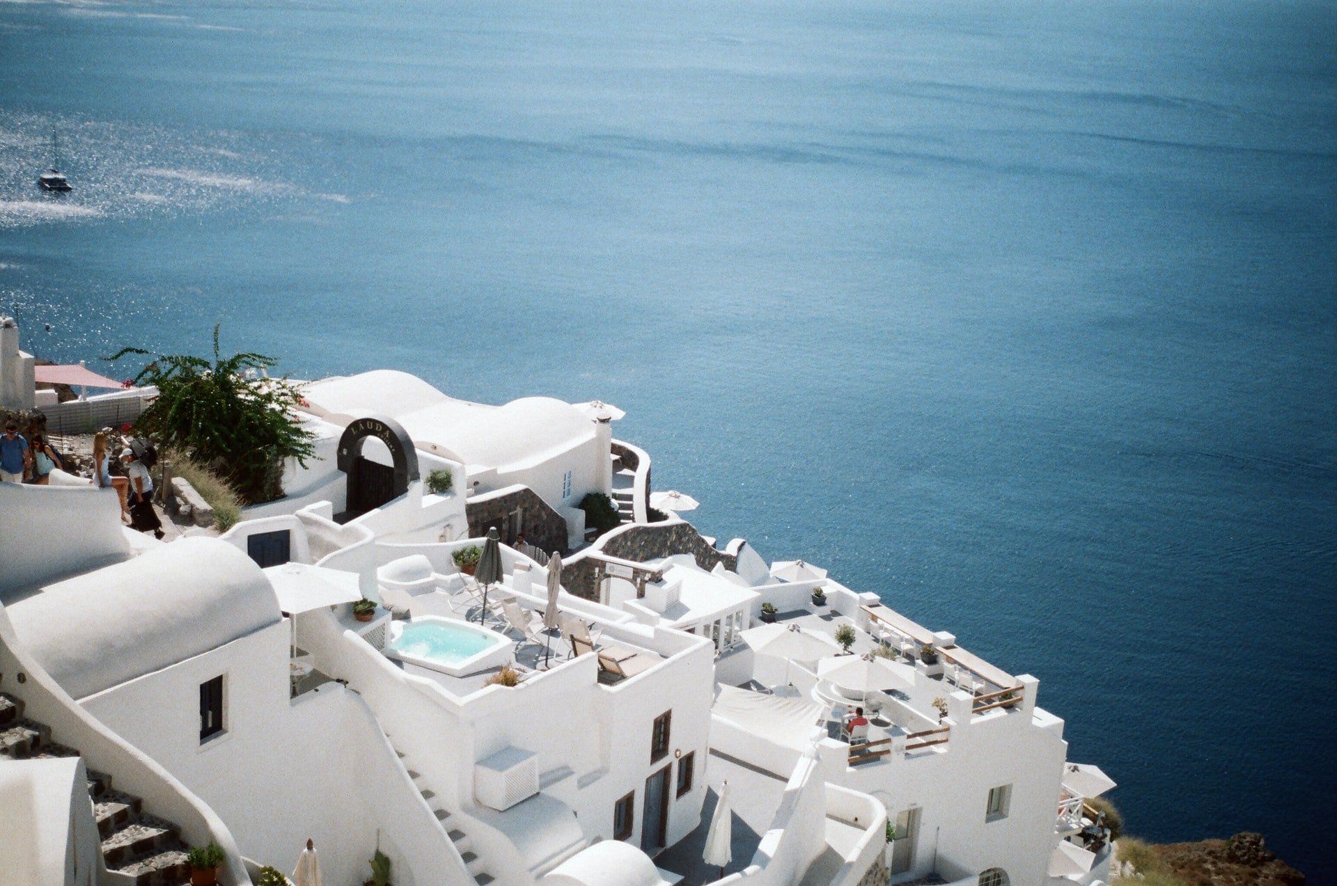 White buildings with blue accents overlooking the Aegean Sea in Santorini, Greece.