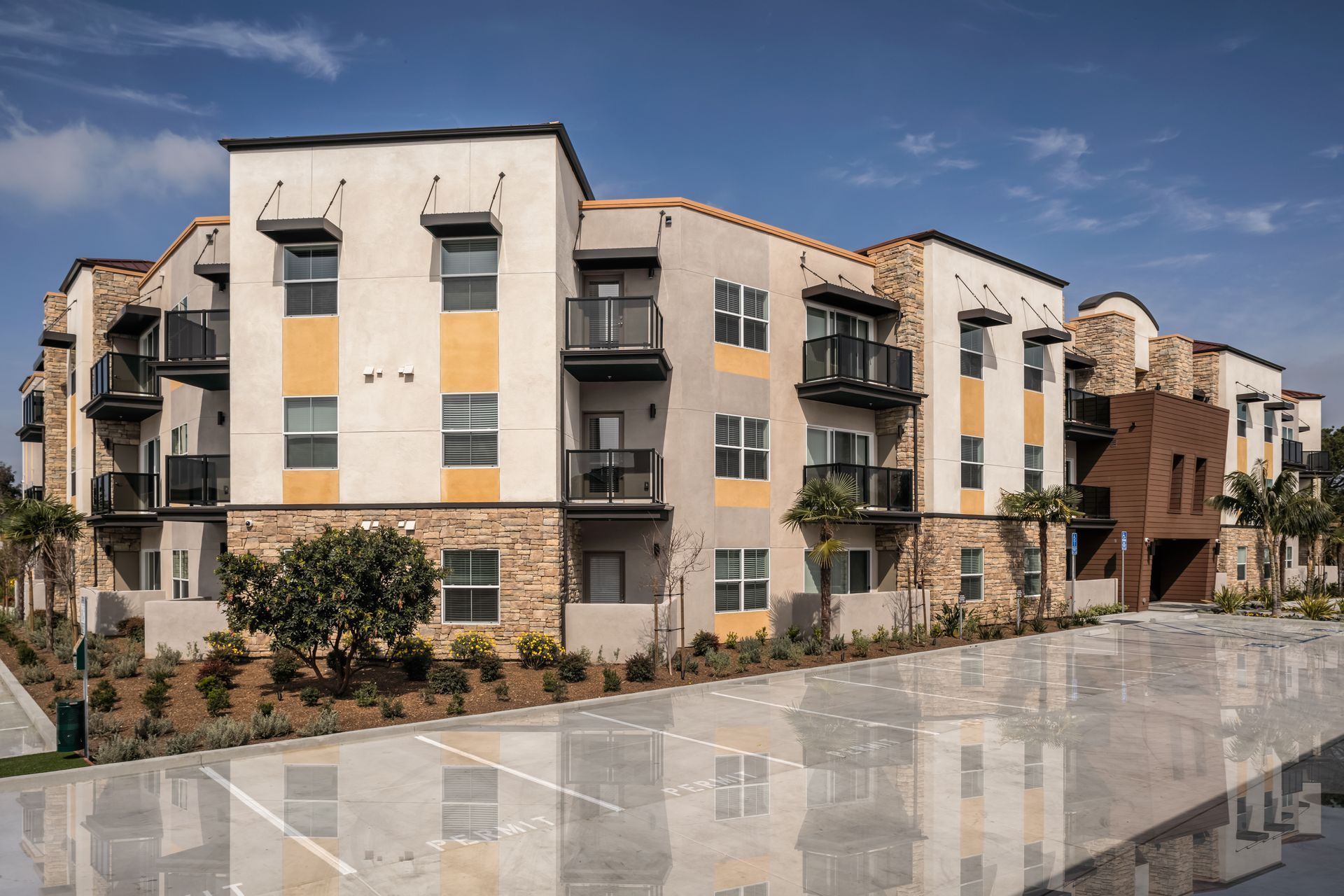A large apartment building with a parking lot in front of it