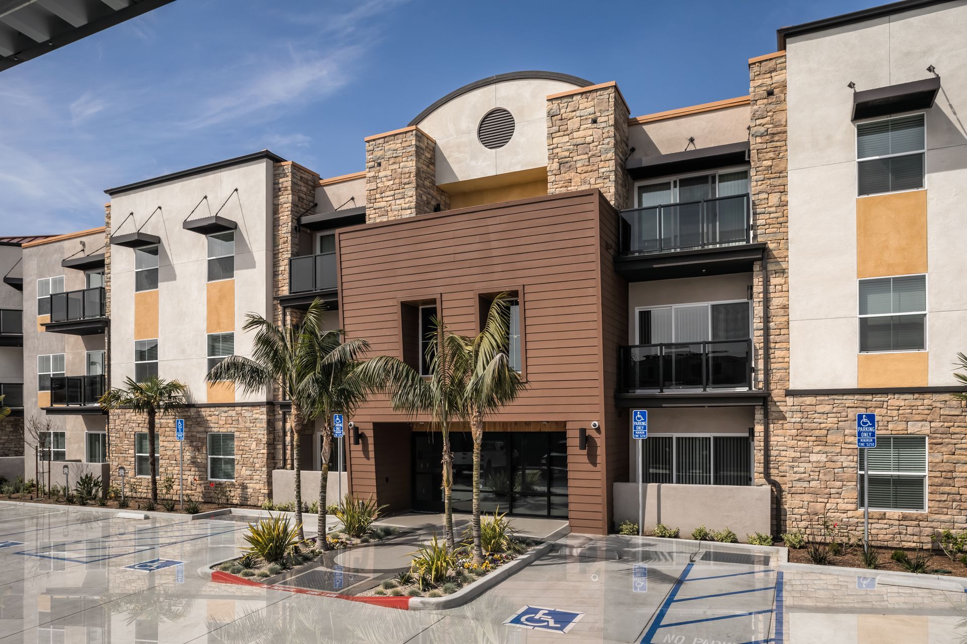 A large apartment building with a handicapped parking spot in front of it