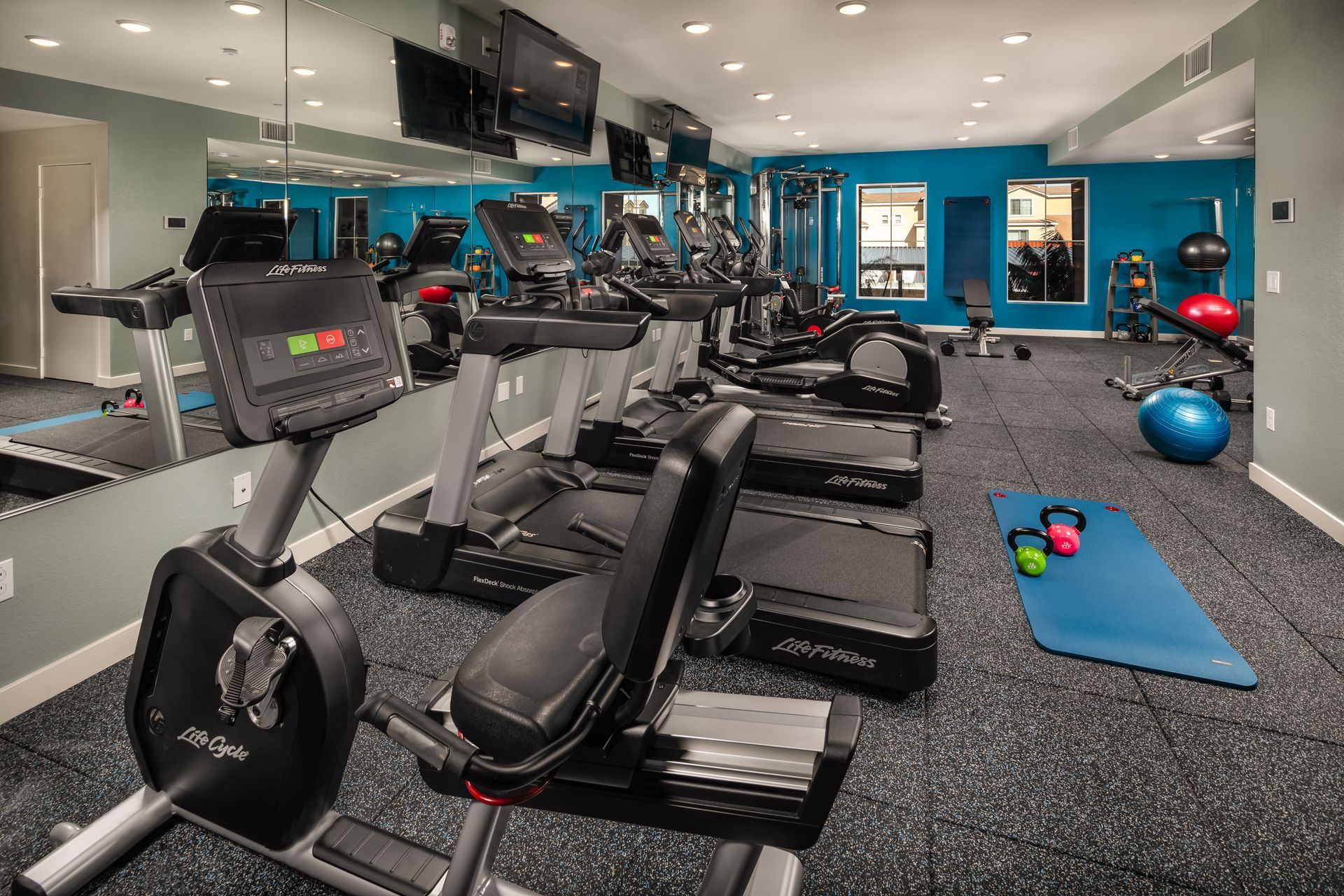A gym with a lot of treadmills and exercise bikes.