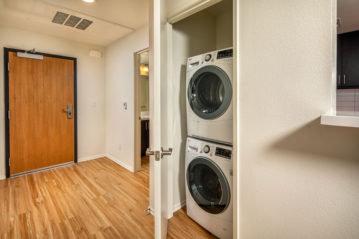 A washer and dryer are stacked on top of each other in a laundry room.