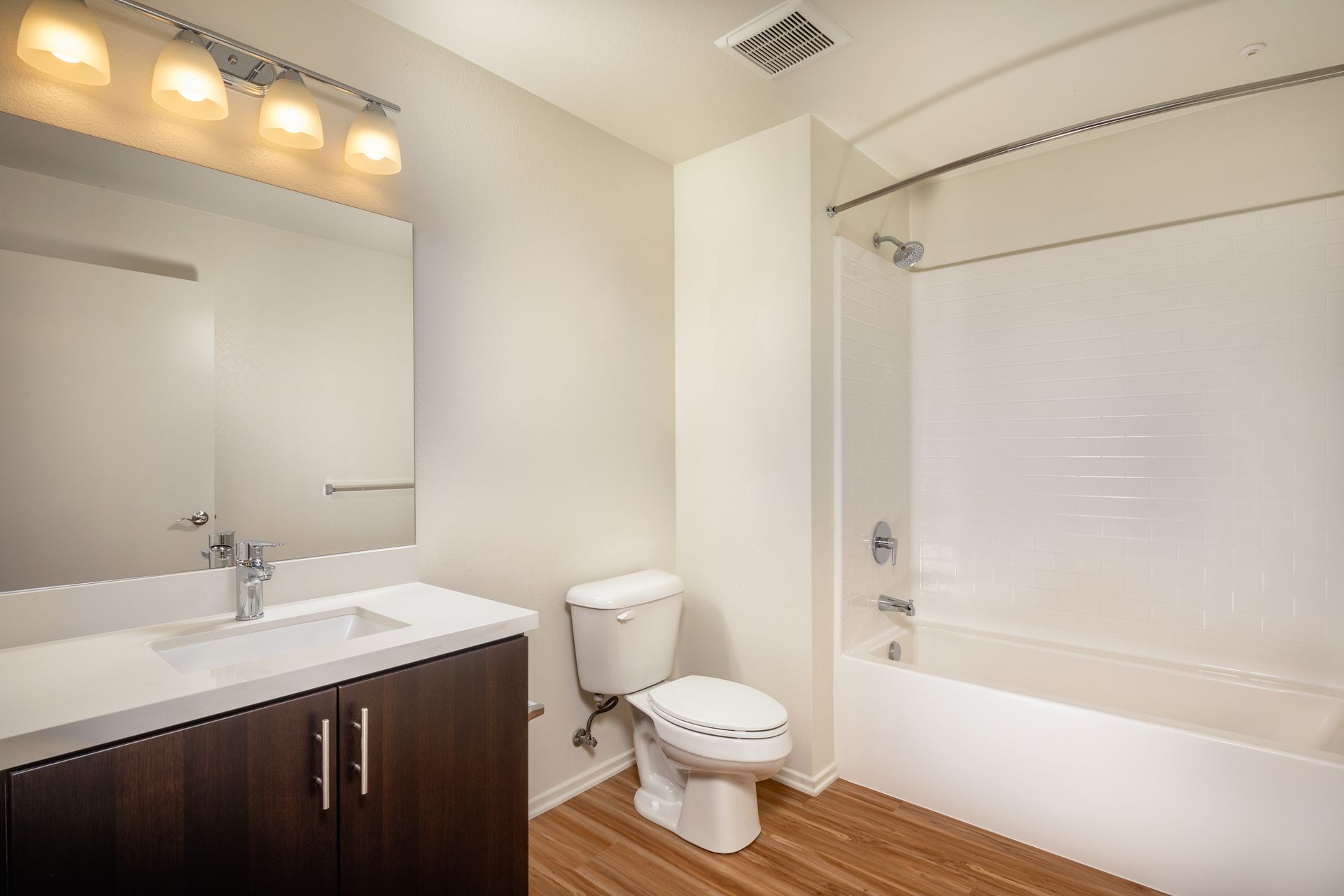 A bathroom with a toilet , sink , and bathtub.