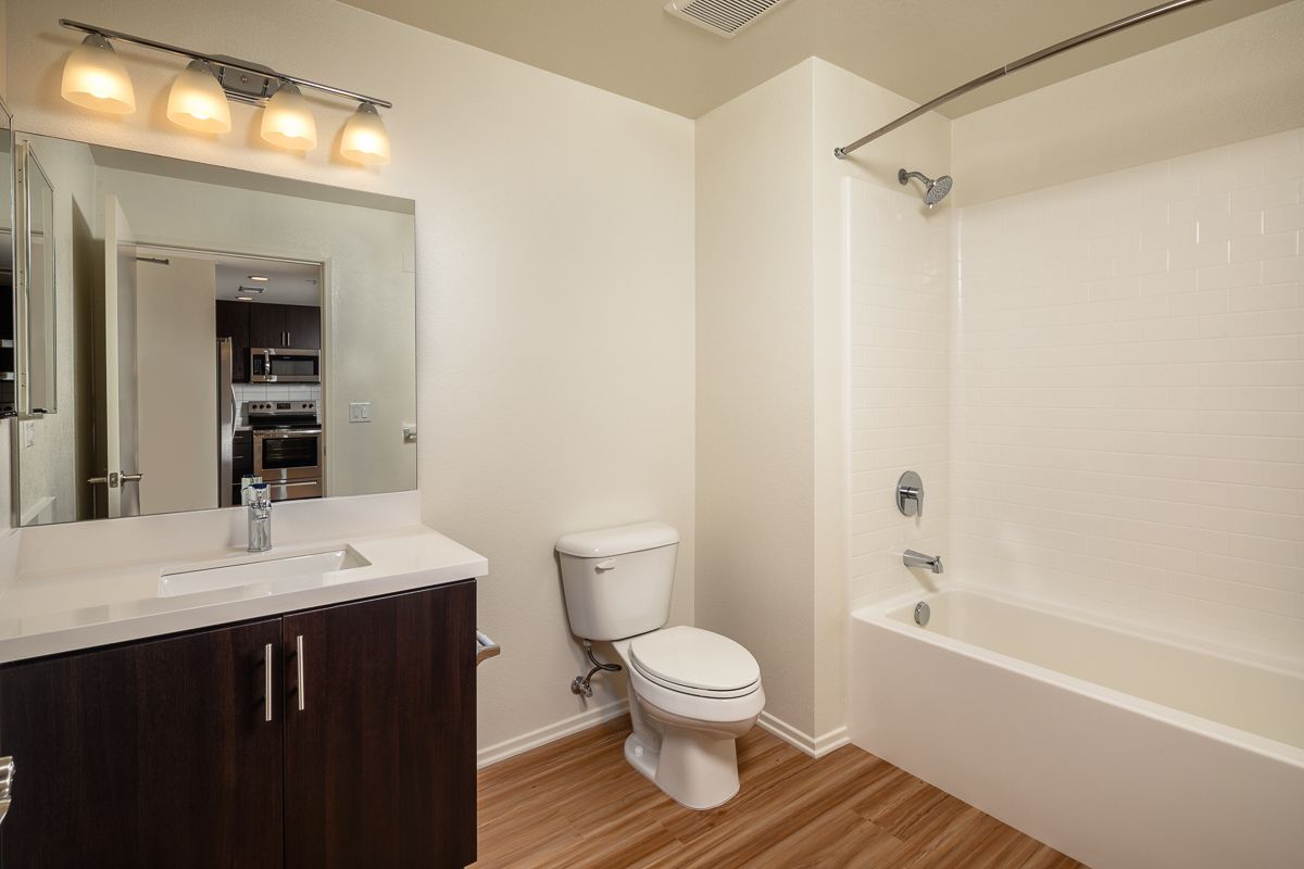 A bathroom with a toilet , sink , and bathtub.