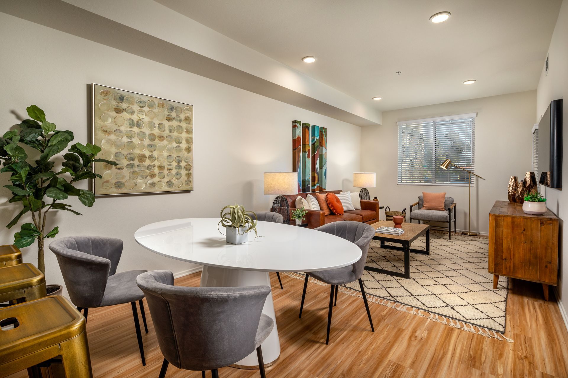 A living room with a dining table and chairs and a couch.