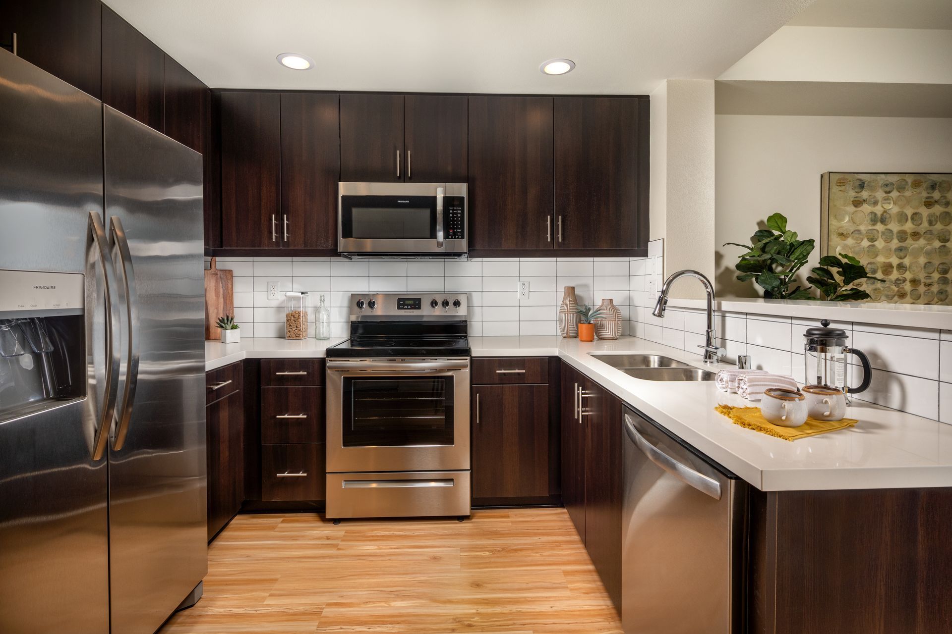 A kitchen with stainless steel appliances and wooden cabinets.