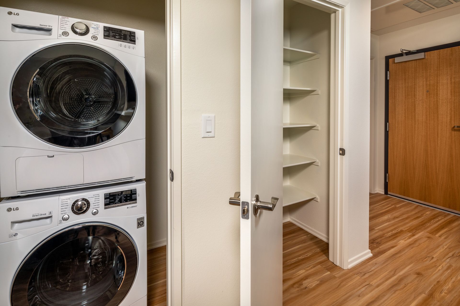 A washer and dryer are stacked on top of each other in a laundry room.