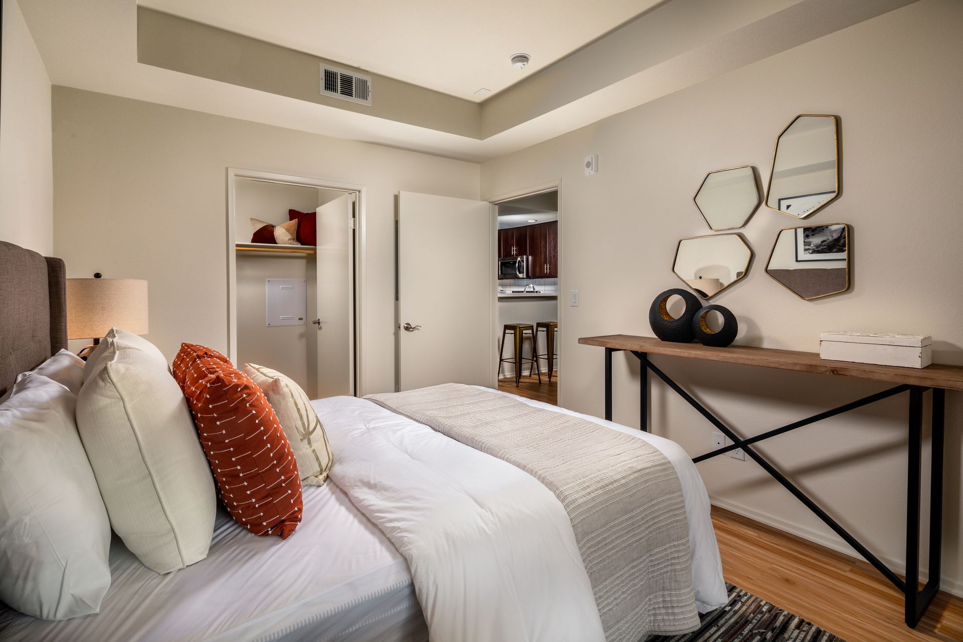 A bedroom with a large bed and a wooden table.