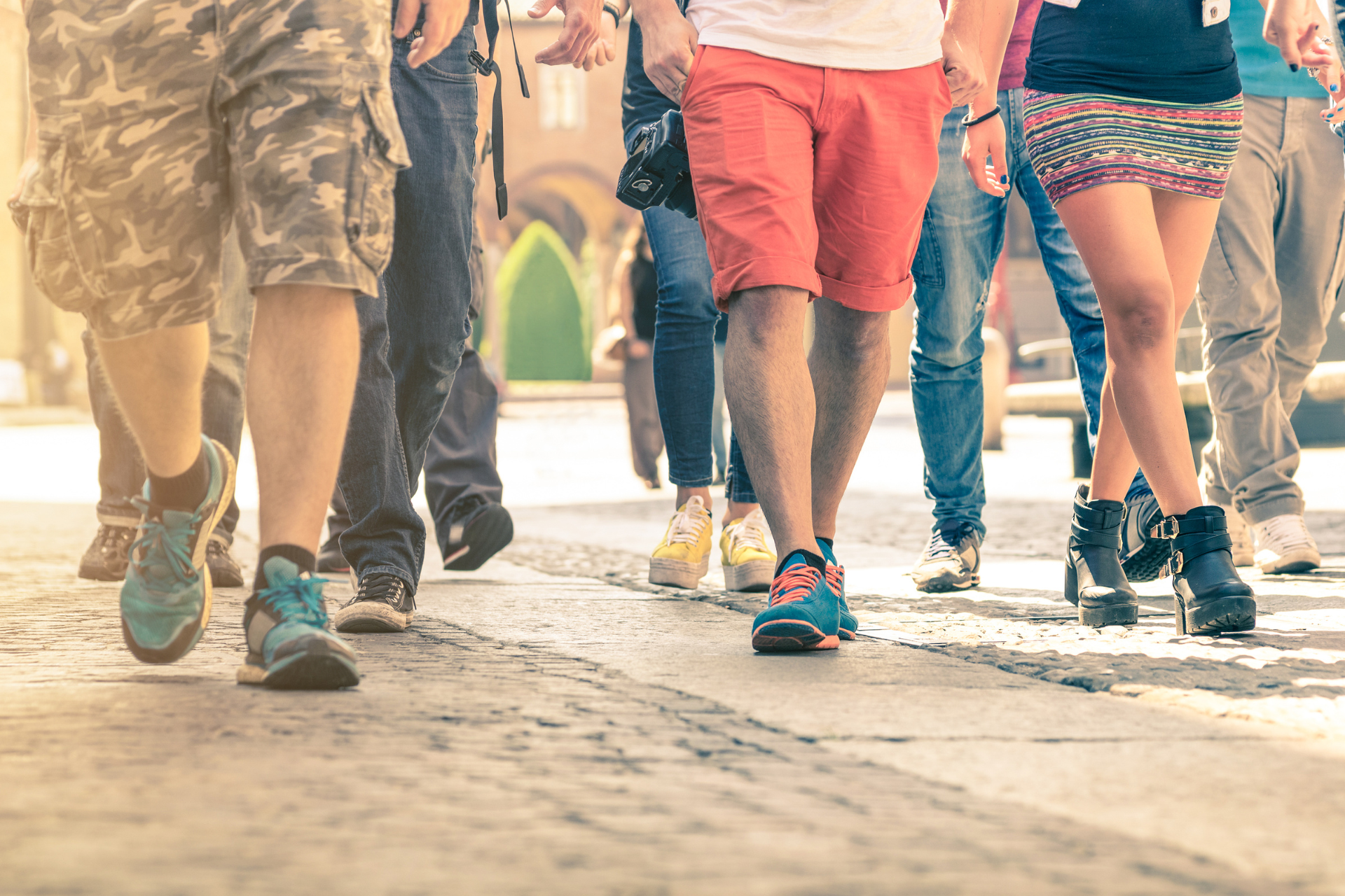 A group of people are walking down a street.