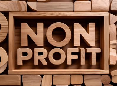 Wooden blocks spelling “NON PROFIT” on a rustic background.