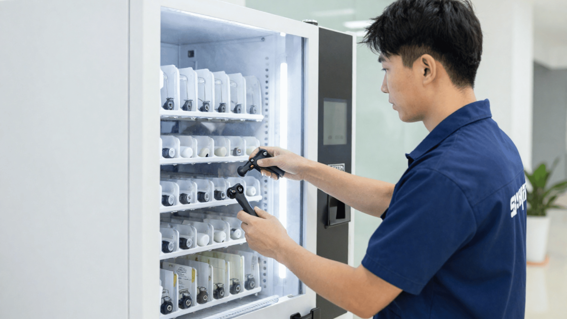 Professional vending services with a commercial vending supplier restocking and maintaining vending machines for businesses