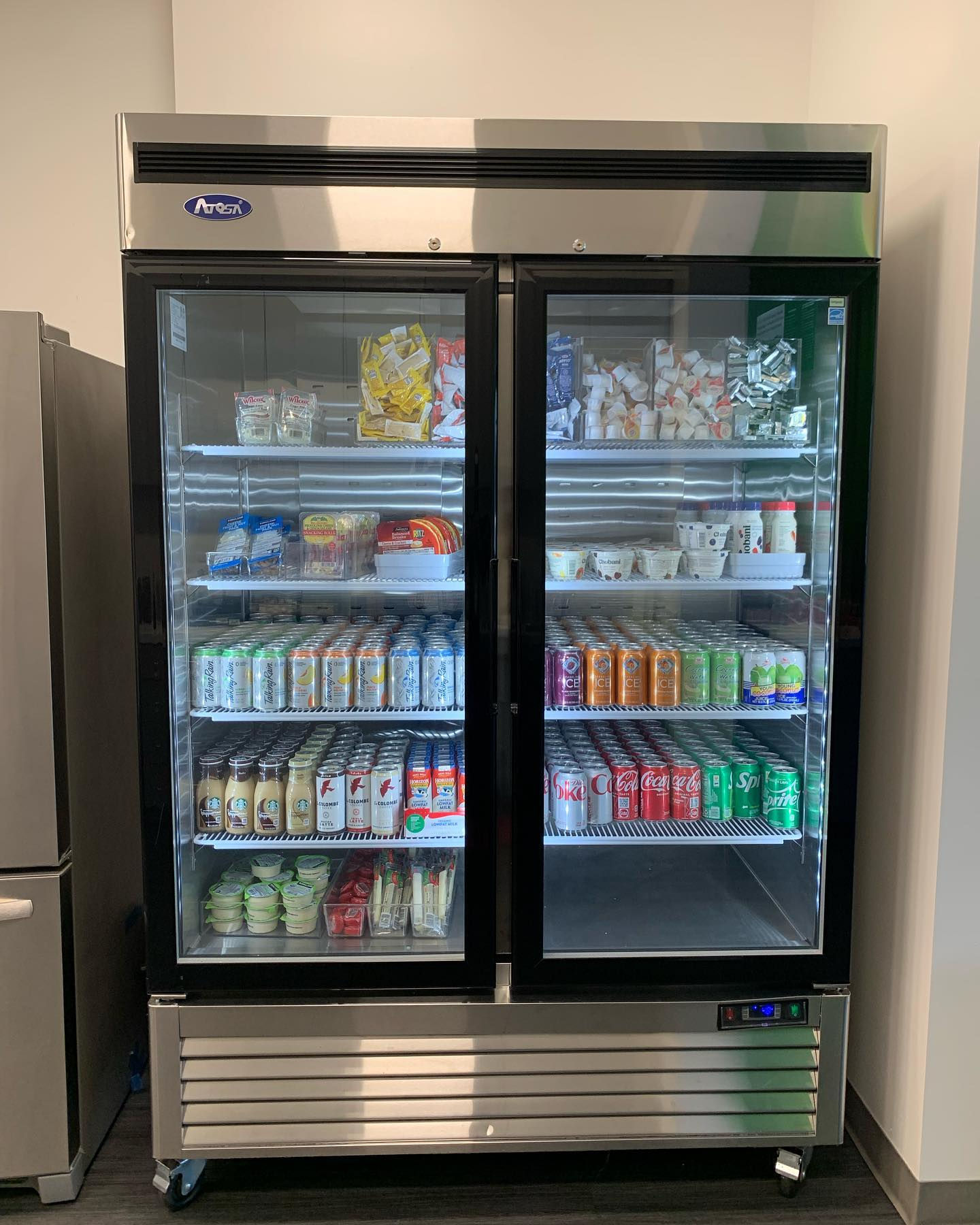 Vending machine with various snacks: chips, crackers, and crisps, with price tags visible.