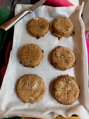 Six baked cookies on parchment paper in a tray