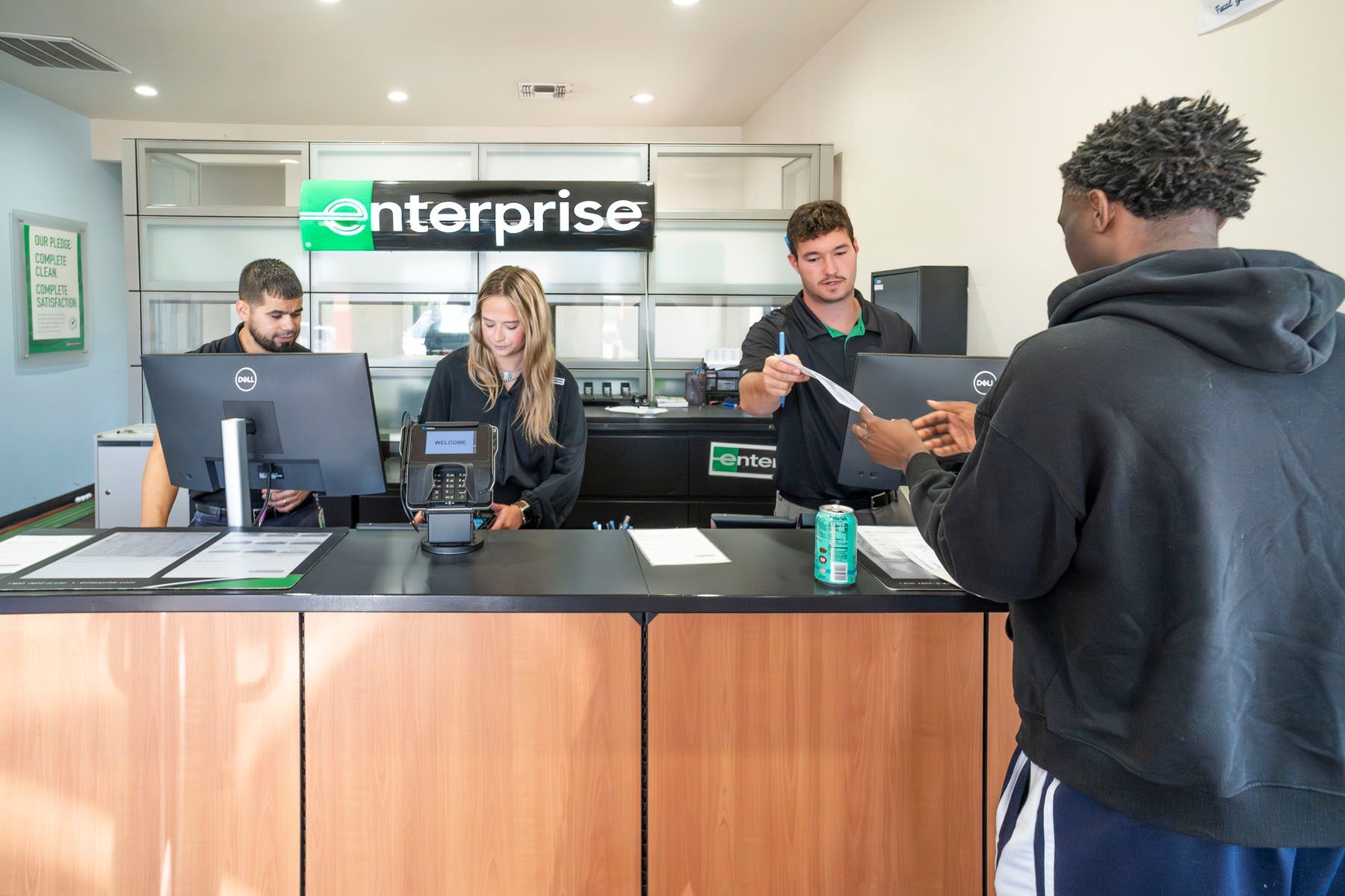 Enterprise rental counter with staff assisting a customer at the desk