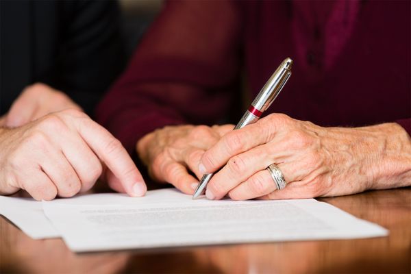 Elder Writing on a Paper — Shawano, WI — Greenhill Law Office