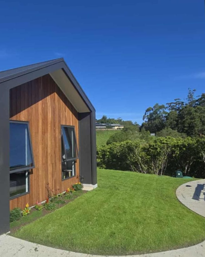 Concrete Steps with A Metal Railing Ascend a Grassy Hillside — East Coast Hydroseeding in Wauchope, NSW